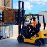 Forklift operation training showing a forklift truck in action with operator handling materials.