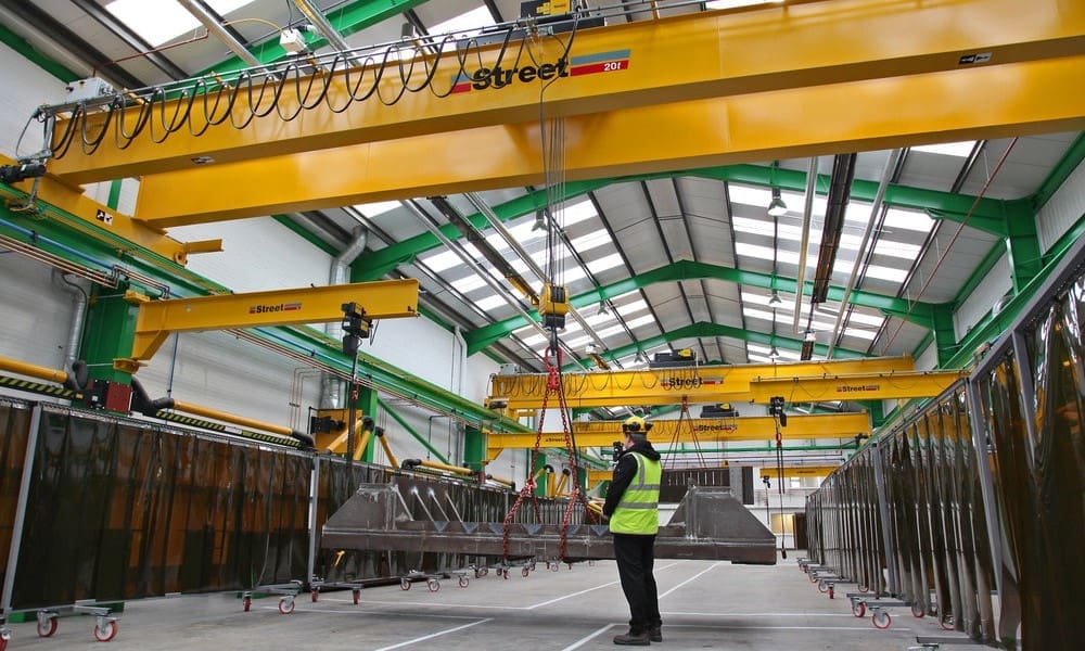 Gantry or overhead crane lifting a suspended load inside an industrial training facility for RIIHAN305D Operate a Gantry or Overhead Crane practical training