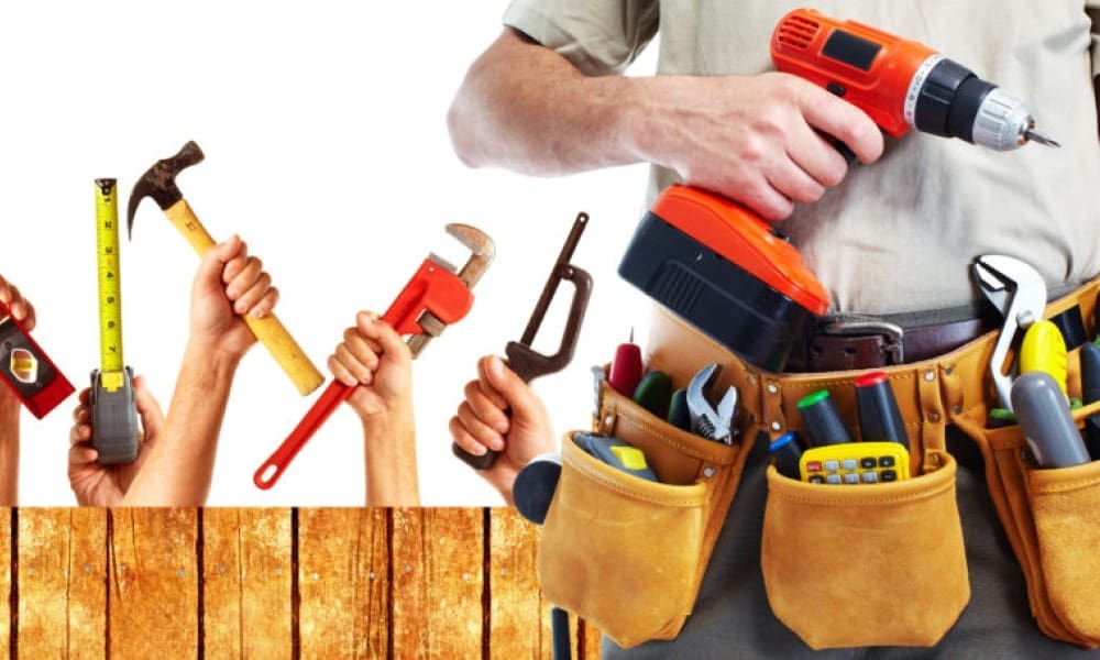 Photo showing a person using hand and power tools (such as drills or saws) on a work surface as part of practical training for safe tool use.