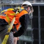 RIIWHS204E Work Safely at Heights training showing personnel using fall protection gear during elevated work.