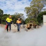 Standard 11 Surface Mining Induction training with workers in safety gear at a mine site.