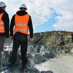 Standard 11 Surface Mining Induction training showing a group of workers at a mine site.