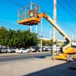 Boom-type elevating work platform (EWP) in use showing articulated boom lift for high-risk work.